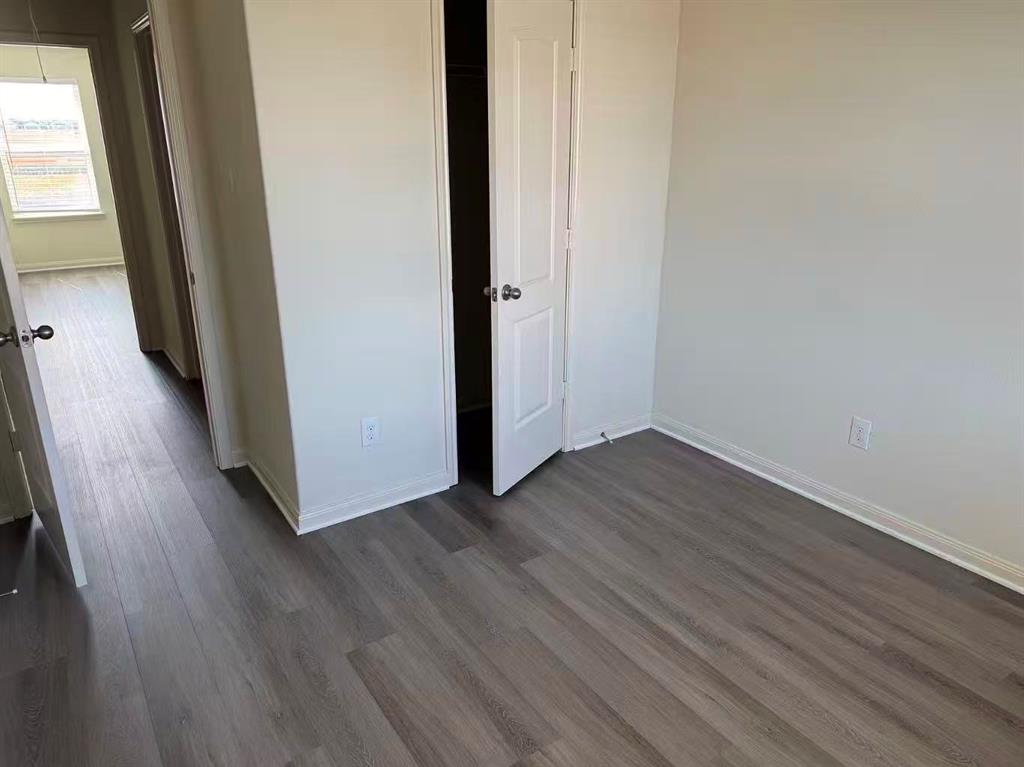 1806 Douglas Street Howe, TX 75459 - Photo 6 of 15 a view of a hallway with wooden floor