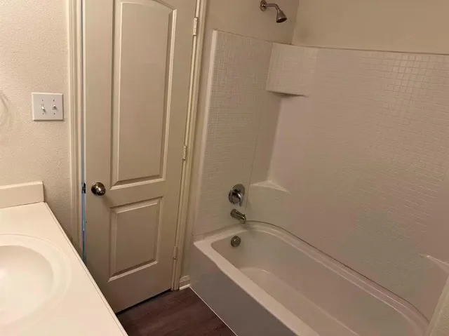 a bathroom with a tub and shower