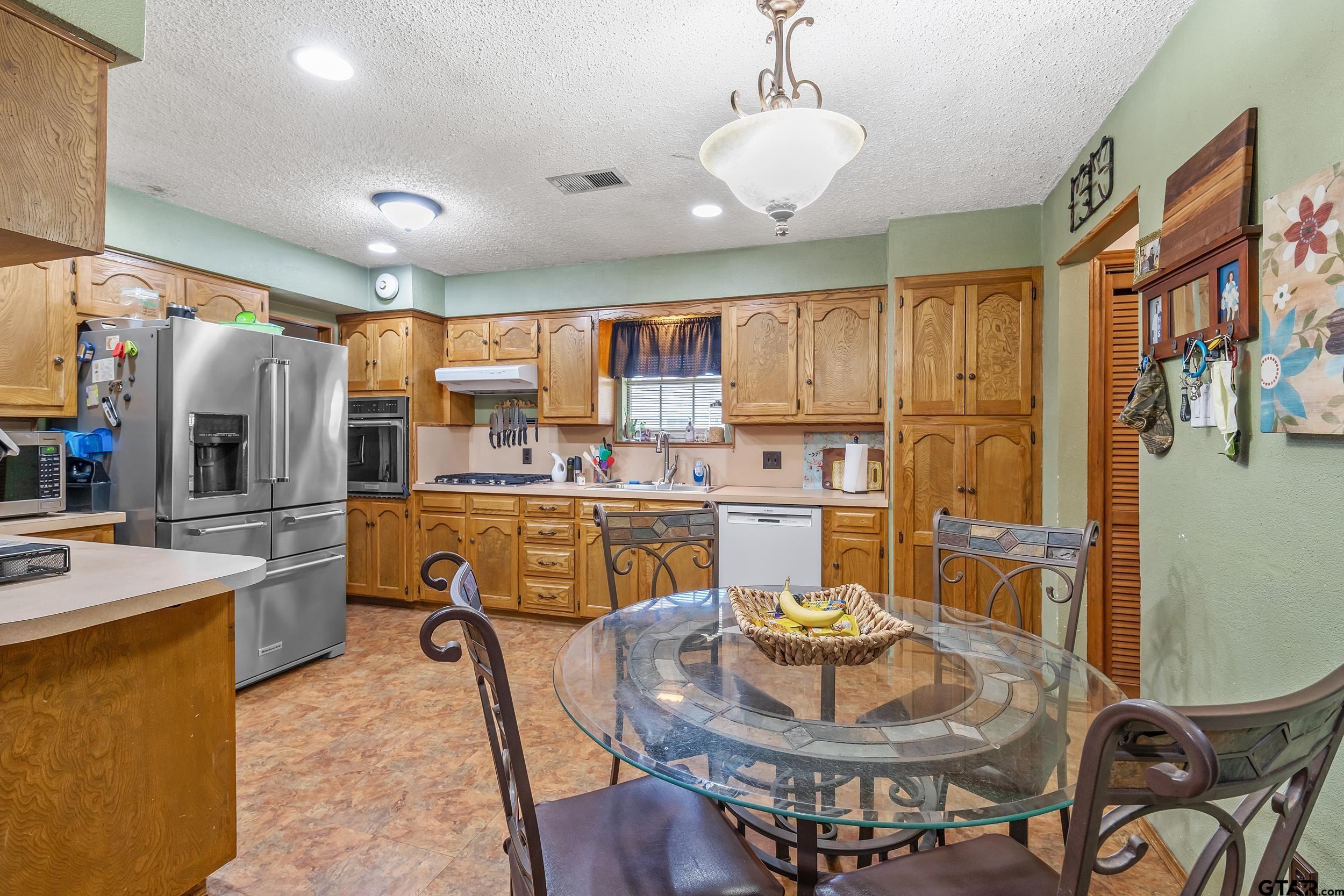 449 Ruth Street Hawkins, TX 75765 - Photo 14 of 33 a living room with stainless steel appliances furniture a dining table and kitchen view