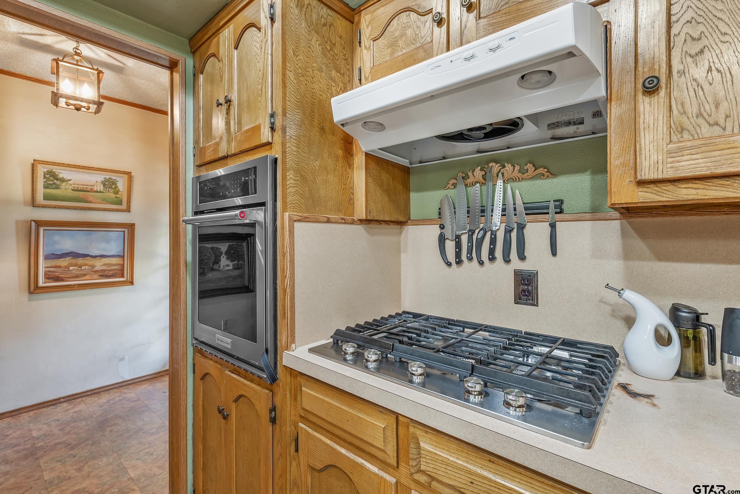449 Ruth Street Hawkins, TX 75765 - Photo 4 of 33 a kitchen with a refrigerator and a stove