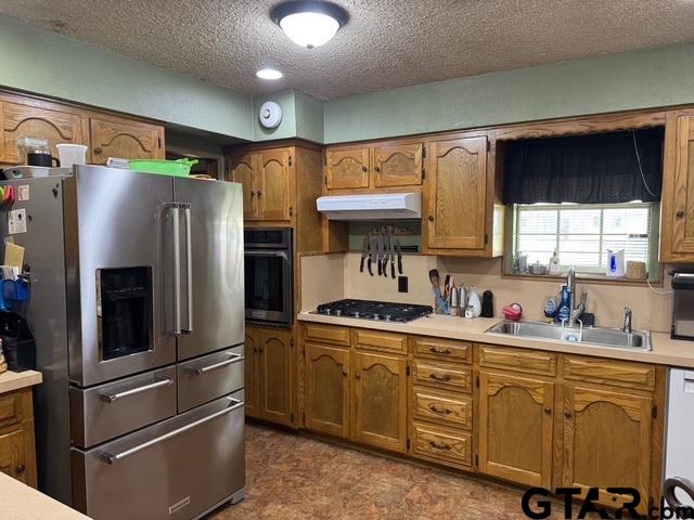 449 Ruth Street Hawkins, TX 75765 - Photo 9 of 33 a kitchen with stainless steel appliances a refrigerator sink and cabinets