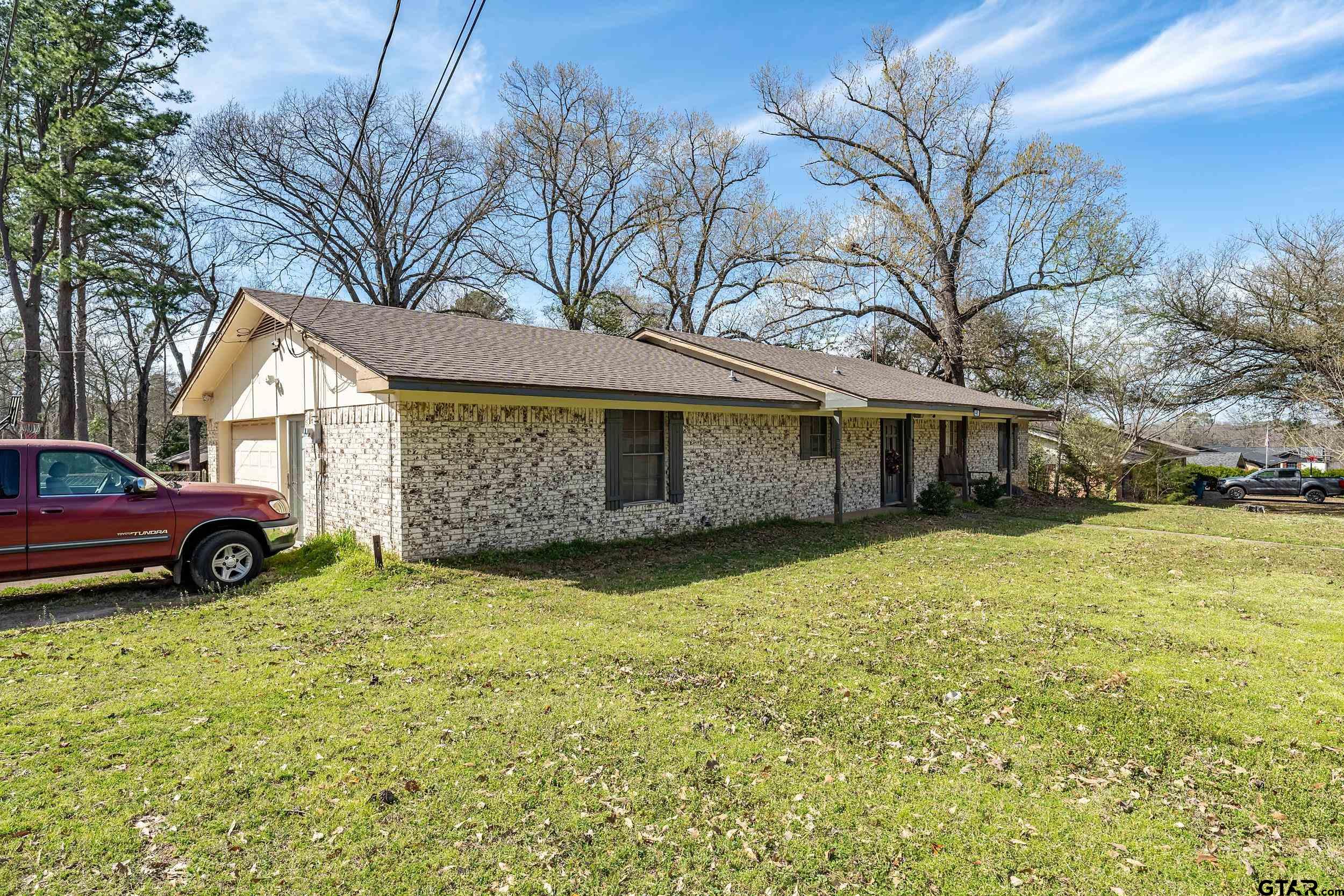449 Ruth Street Hawkins, TX 75765 - Photo 10 of 33 a view of a house with a yard and garage