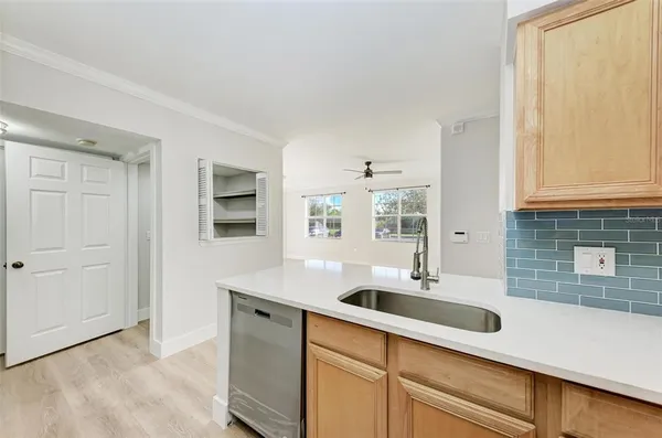 a kitchen with stainless steel appliances granite countertop a sink and a white cabinets