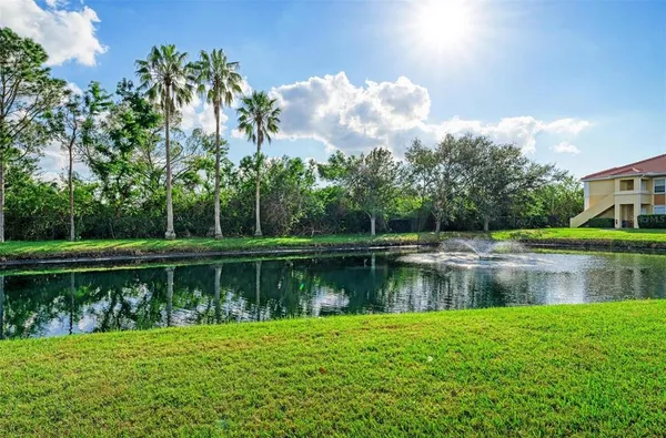 a front view of a house with garden and swimming pool