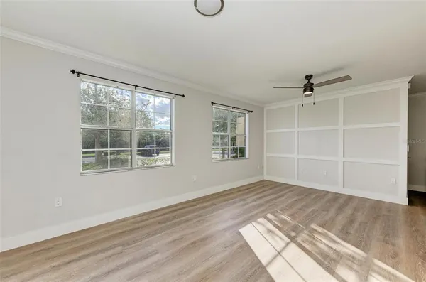 an empty room with windows and cabinet