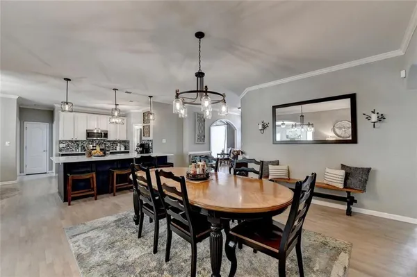 a large kitchen with sink a center island stainless steel appliances and cabinets