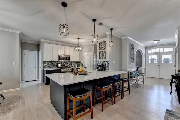 a kitchen with a sink a counter space cabinets and stainless steel appliances