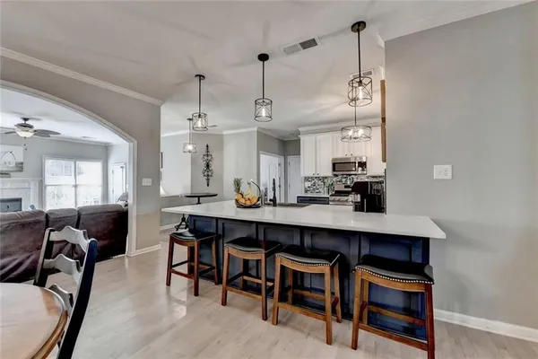 a kitchen with a stove and white cabinets