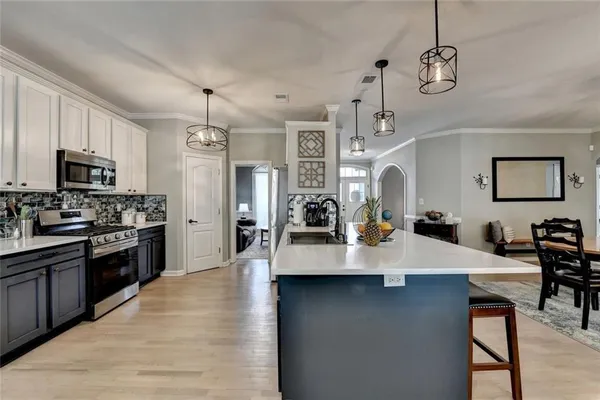 a kitchen with a counter space cabinets and appliances
