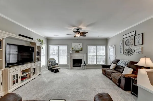 a bedroom with furniture and a large window