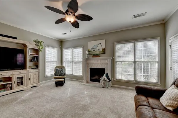 a bedroom with a bed and a flat tv screen on dresser