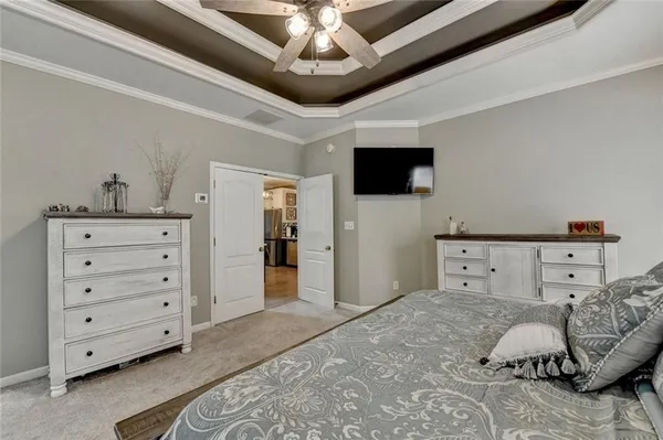 a bedroom with a bed and a ceiling fan