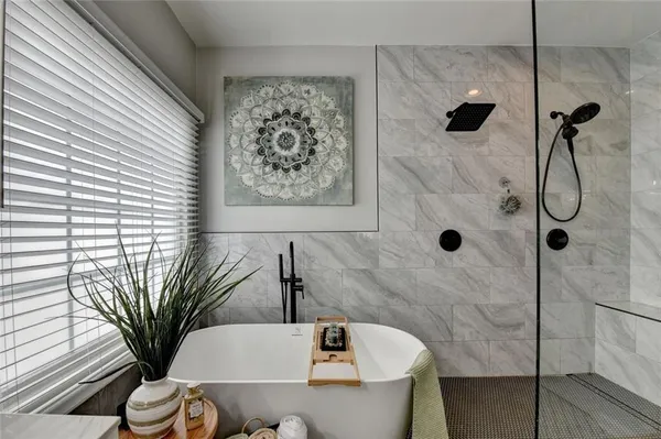 a bedroom with a bed a couch and a window