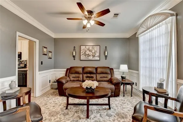 a view of a livingroom with workspace and a window