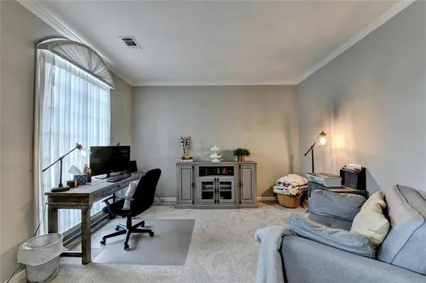 a dining room with furniture a chandelier and wooden floor
