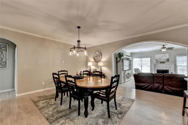 a view of a dining room with furniture and chandelier