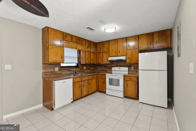 a view of a kitchen with a sink and a window