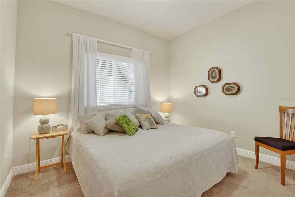 6020 Plover Meadow Street Lithia, FL 33547 - Photo 13 of 41 a bedroom with a bed and a lamp