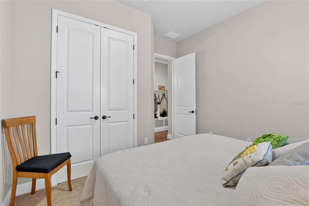 6020 Plover Meadow Street Lithia, FL 33547 - Photo 14 of 41 a bedroom with a bed and a chair