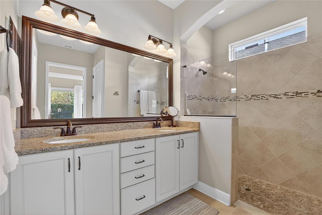 6020 Plover Meadow Street Lithia, FL 33547 - Photo 23 of 41 a bathroom with a granite countertop sink mirror and double