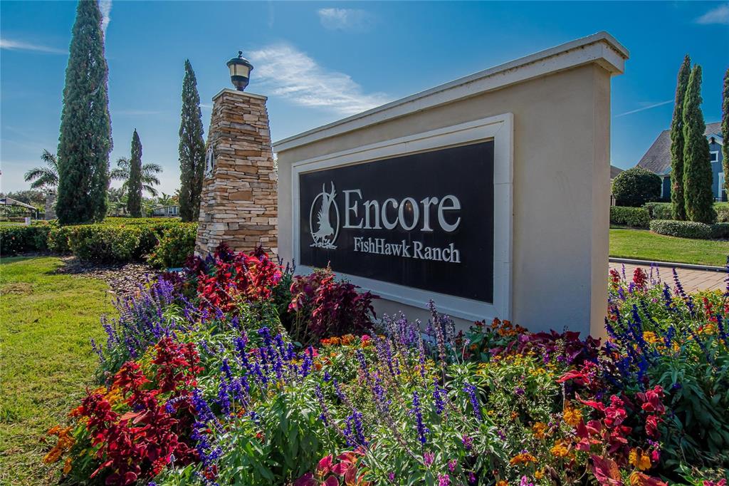 6020 Plover Meadow Street Lithia, FL 33547 - Photo 33 of 41 a sign that is in front of flowers