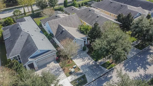 an aerial view of a house with a yard