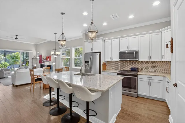 a kitchen with white cabinets and appliances