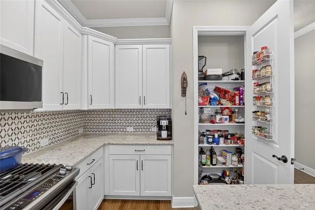 a kitchen with stainless steel appliances a stove a microwave and cabinets