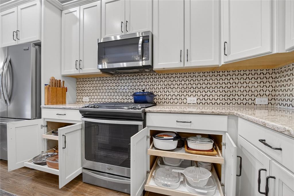 6020 Plover Meadow Street Lithia, FL 33547 - Photo 7 of 41 a kitchen with stainless steel appliances a stove a microwave and cabinets