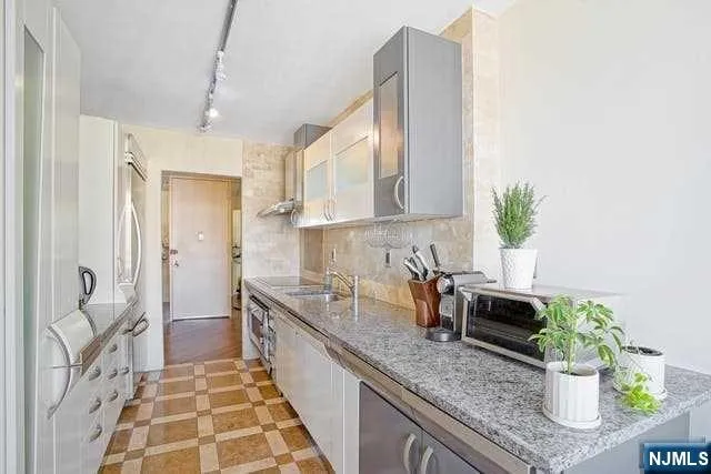 a large kitchen with a stove a sink and a refrigerator