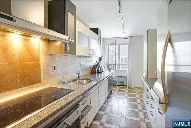 a kitchen with a sink and a refrigerator