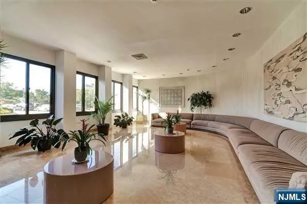 a living room with furniture potted plant and windows