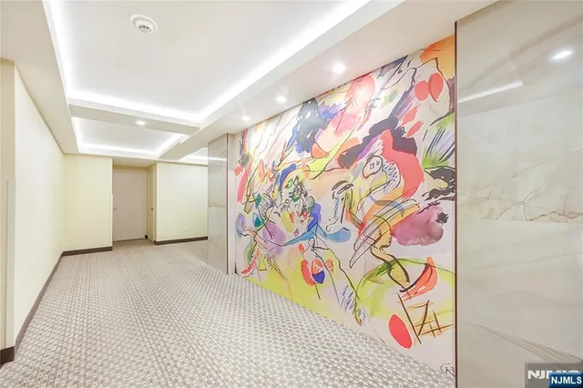 a view of a hallway with wooden floor and closet