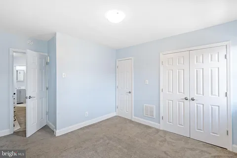 an empty room with closet area