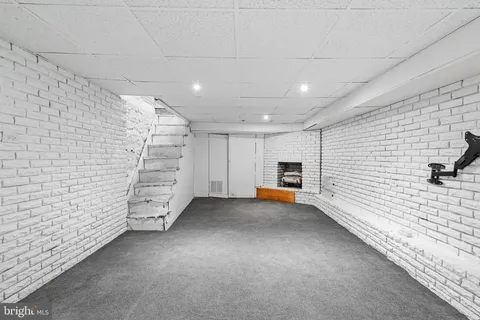 a view of an empty room with a brick wall