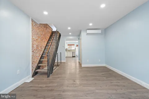 a view of entryway with wooden floor and stairs