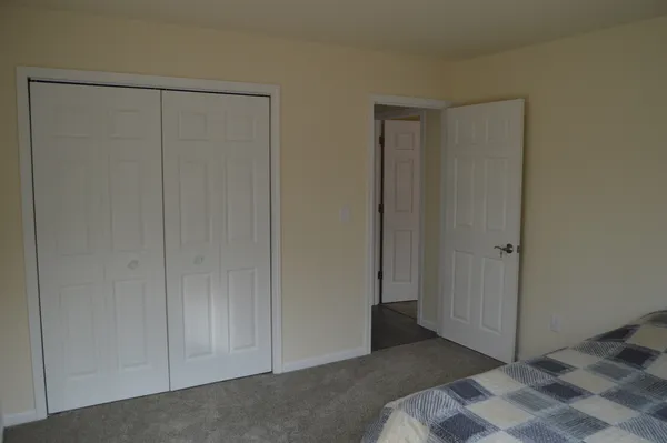 a bed sitting in a bedroom next to a window