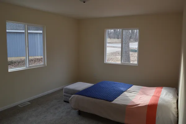 a view of empty room with closet and wooden floor