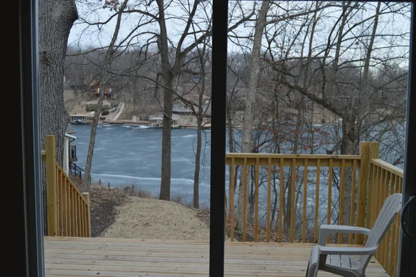 a view of a wooden bridge with a large tree