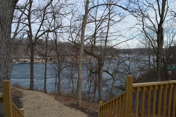 a living room with furniture a flat screen tv and a large window
