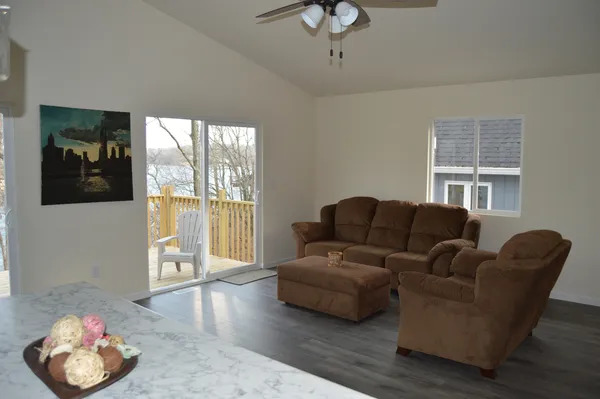 a kitchen with stainless steel appliances a table chairs refrigerator and microwave