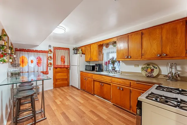 a kitchen with stainless steel appliances granite countertop a stove a sink and a refrigerator