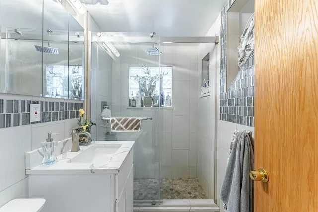 a bathroom with a sink toilet and shower