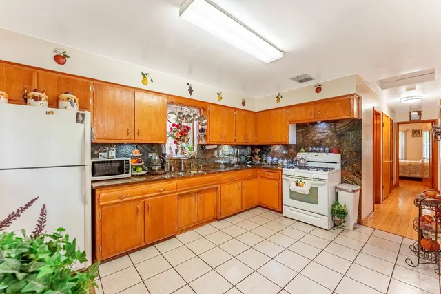 a kitchen with granite countertop appliances and cabinets