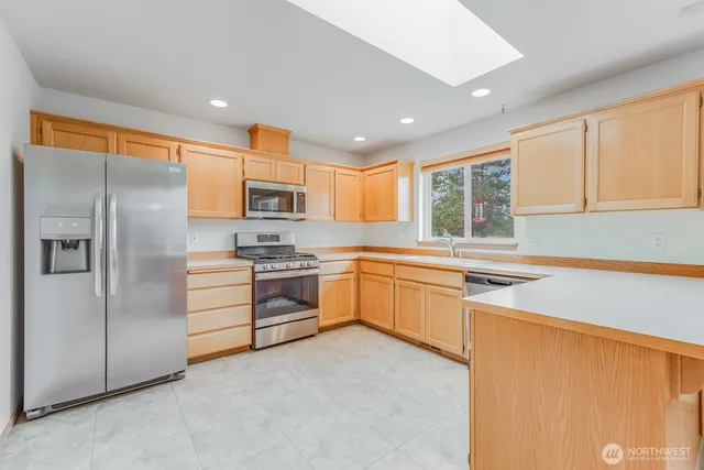 a view of empty room with wooden floor and fireplace