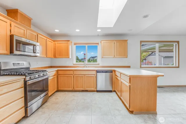 a view of a hallway view with wooden floor and a window