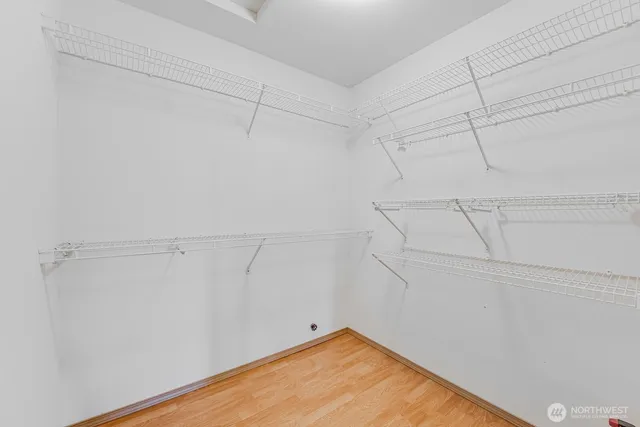 a bathroom with a granite countertop sink a toilet and a large mirror
