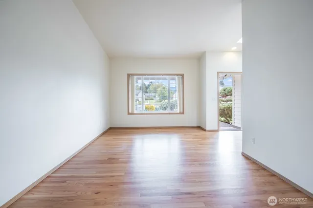a view of kitchen with stainless steel appliances granite countertop a stove and a refrigerator