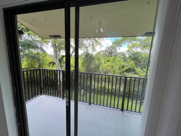 a view of a balcony with a floor to ceiling window