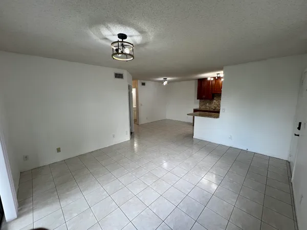 a view of a livingroom with furniture and chandelier fan